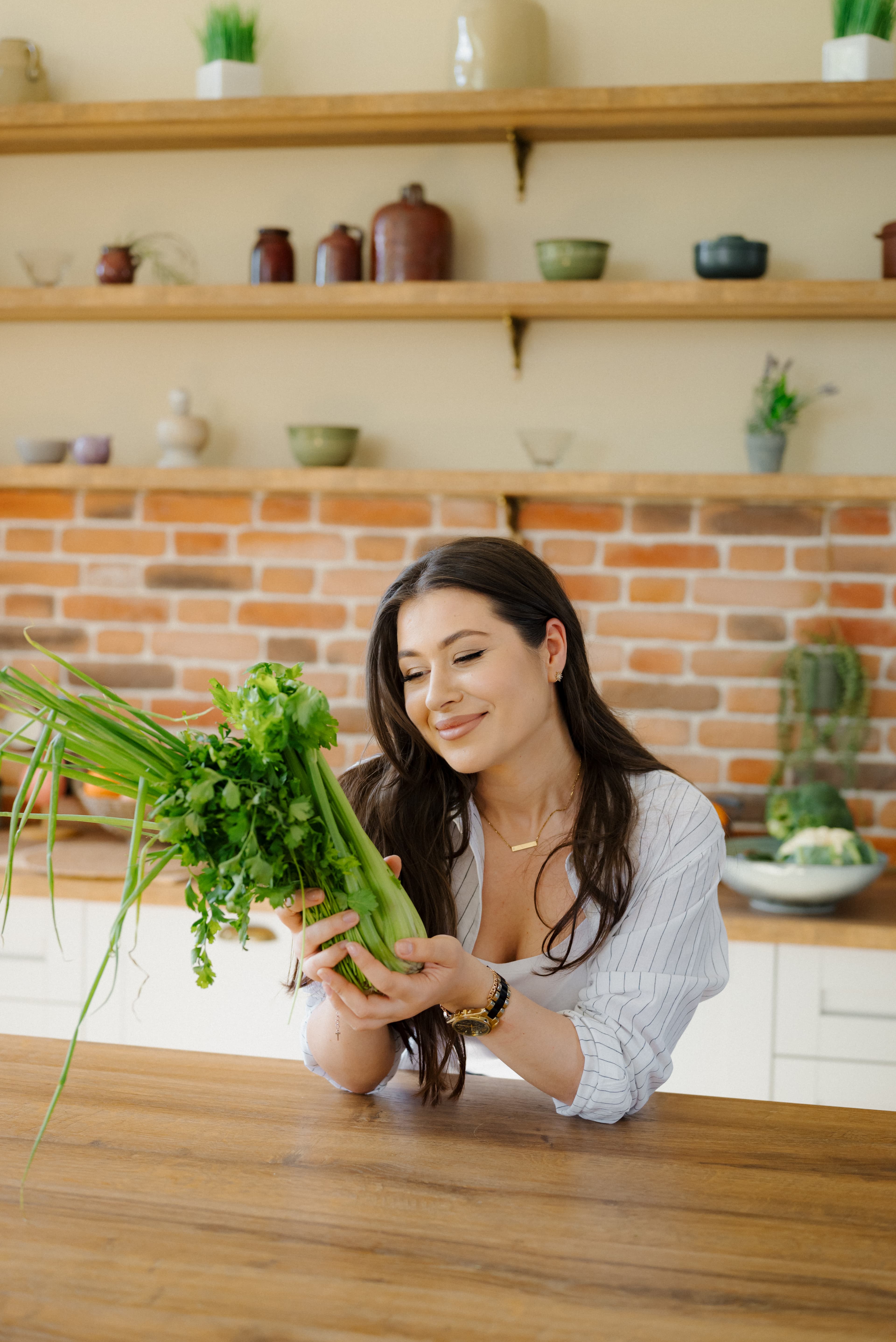 Tatiana smiling in her kitchen, holding fresh oranges